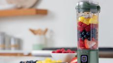 Ninja Blast in pale green blending a fresh fruit smoothie