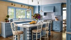 A blue kitchen with natural textured wallpaper