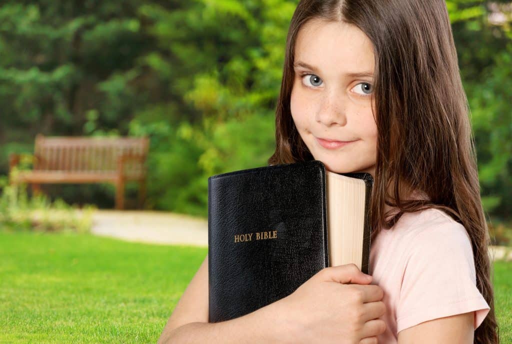 girl holding Bible